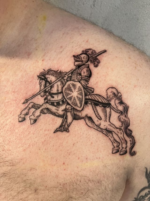 Fine line etching-style knight on a galloping horse, across a chest.